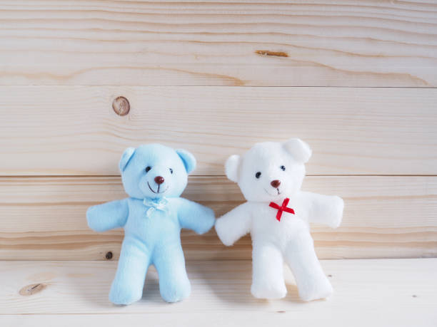 istock Blue and white toy teddy bear on wooden background 641924948