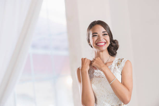 Young mixed race woman in white dress Portrait of a mixed race teenage girl wearing a white dress. She is ready for a special occasion, perhaps her prom or birthday party. prom fashion stock pictures, royalty-free photos & images