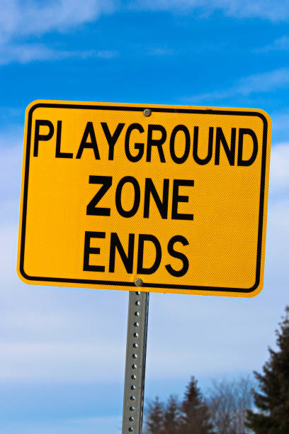 istock Playground Zone End Sign Against Blue Cloudy Sky and Trees 641925382
