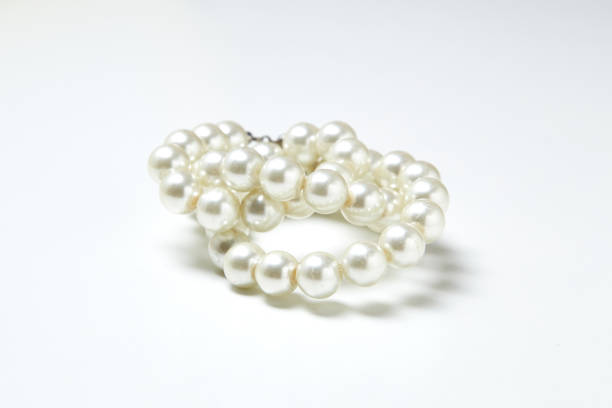 istock pearl necklace isolated on White clouds 641925586