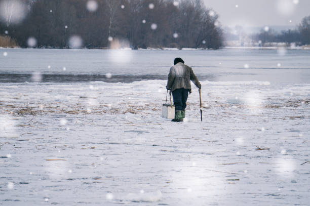 istock Fishing on the river in the winter 641933602