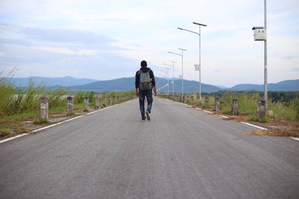 istock Man walking on road in Rayong Thailand 641935464
