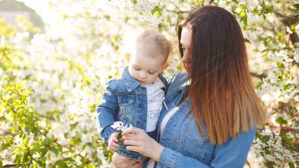 istock Mother and daughter near a flowering tree 641937170