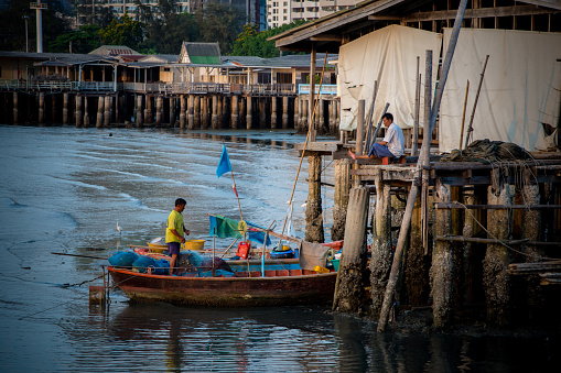 Unidentified fisherman prepare the fishing net at small boat in Sriracha, Chonburi, Thailand on 1 May 2016