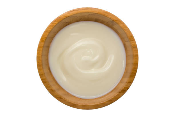istock yogurt in wooden bowl isolated on white 641940160