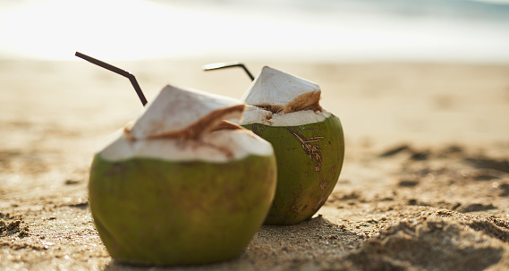 Shot of two drinks made from the husk of a coconut