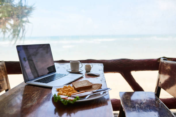 breakfast with the best view - on beach laptop working imagens e fotografias de stock