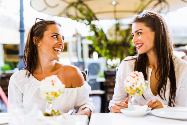 istock Beautiful young women smiling and having a fruit salad 641944890