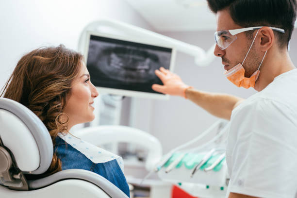istock Dentist showing a patient her x-ray 641947570