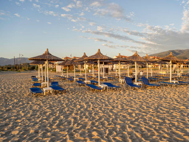 istock View on sand beach with bedstones under straw umbrellas. 641951874