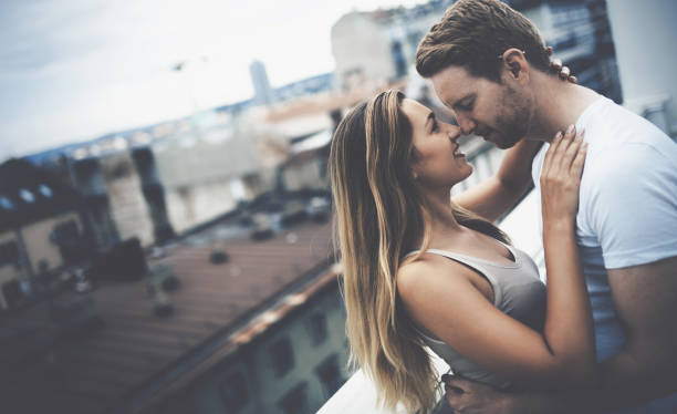 istock Romantic couple kissing on rooftop 641952178