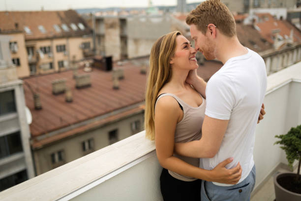 istock Romantic couple kissing on rooftop 641953820