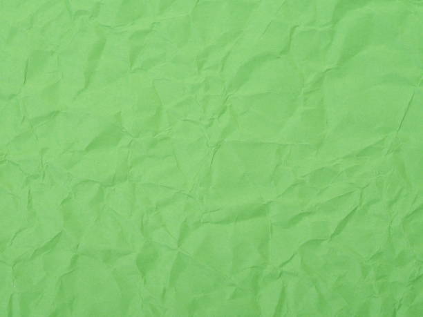 istock Green crumpled paper texture background 641954334