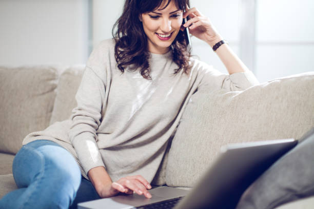 istock Happy girl using laptop at home 641957640