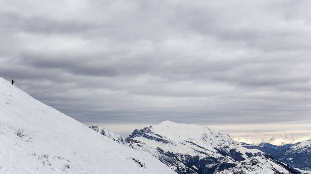 istock Man moving up to top mountain panorama 641958460