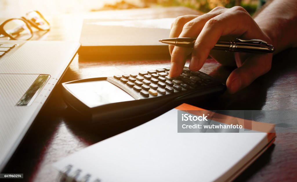 Businessman hand calculate bout cost with laptop for search data. Vat Stock Photo