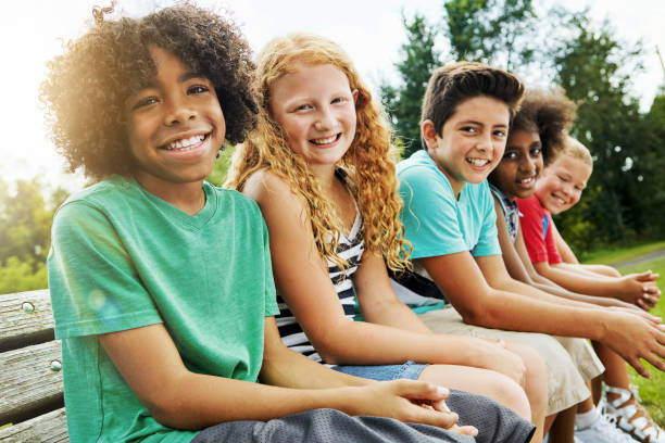 It's always fun when we're together Portrait of a group of diverse and happy kids hanging out together outside pre adolescent child stock pictures, royalty-free photos & images