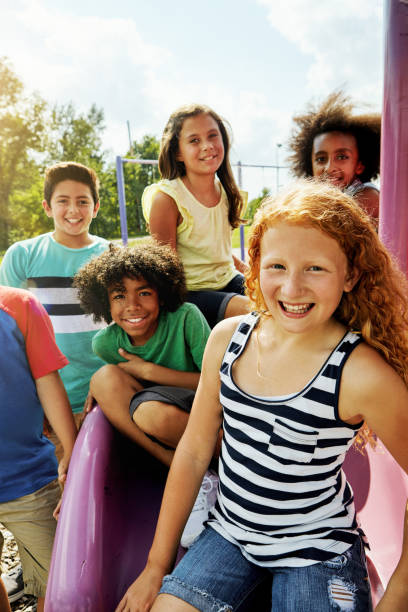 The park is our favourite summer hangout Portrait of a group of diverse and happy kids hanging out together outside children only stock pictures, royalty-free photos & images