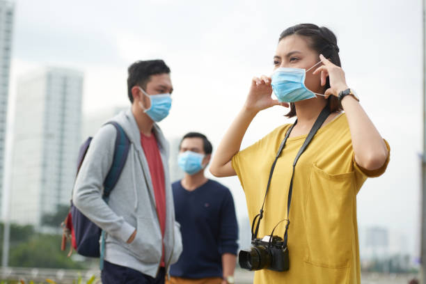 istock Asian woman putting on protective mask 641962694