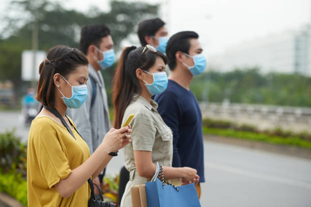 istock Asian pedestrians in protective masks 641962702