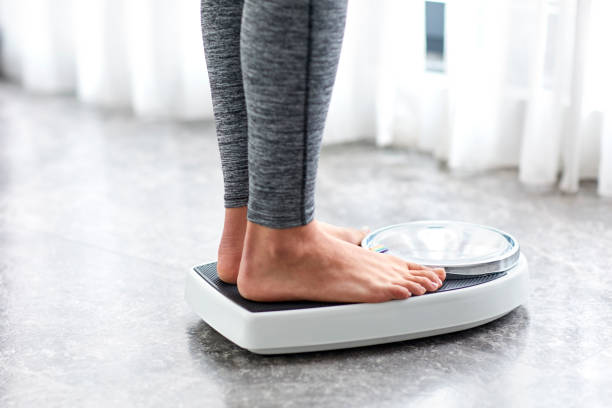 Young Healthy Girl On Home Scales Stock Photo - Download Image Now -  Dieting, Weight Scale, Weight - iStock