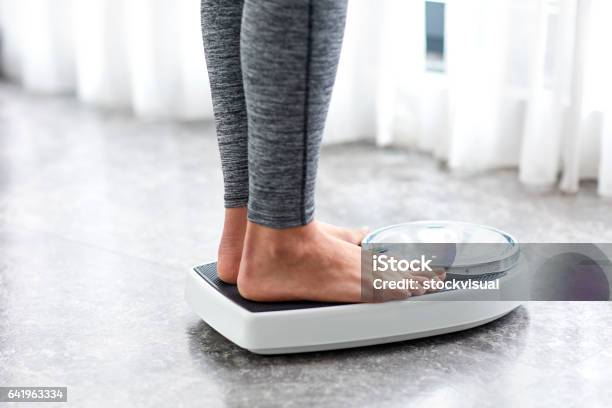Young Healthy Girl On Home Scales Stock Photo - Download Image Now - Dieting, Weight Scale, Weight