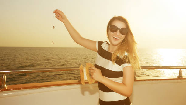 istock smiling woman on yacht with kite 641963340