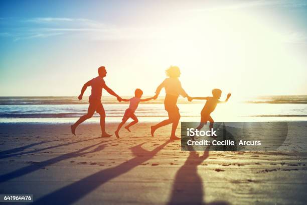 Hand In Hand Across The Sand Stock Photo - Download Image Now - Family, Beach, Running