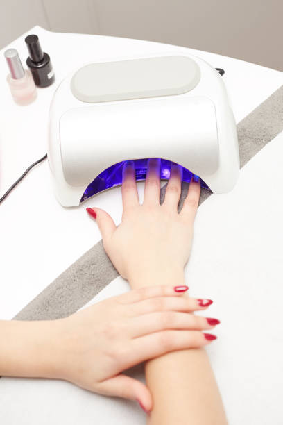 istock closeup of a uv lamp with a female hand inside 641964930