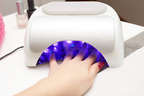 istock closeup of a uv lamp with a female hand inside 641965112