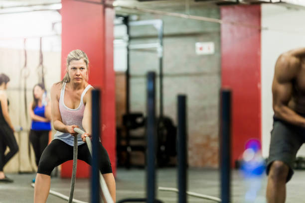 istock Athlete is doing battle rope exercise at gym 641971122