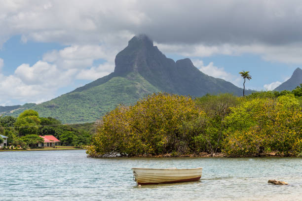 Rempart peak from Tamarin Bay, Black River District, Mauritius Island. Wooden boat in the foreground.