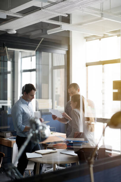 Business people discussing over document in office