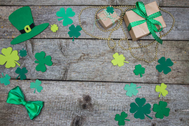 istock Leaf clover, Patricks hat, gold beads and gifts on wooden table 641971820