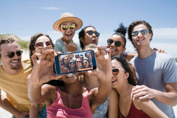 istock Group of friends taking selfie at beach 641972360