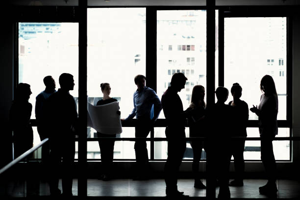 istock Silhouette business people standing in office 641972590