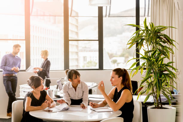 istock Female professionals planning at table in office 641973070