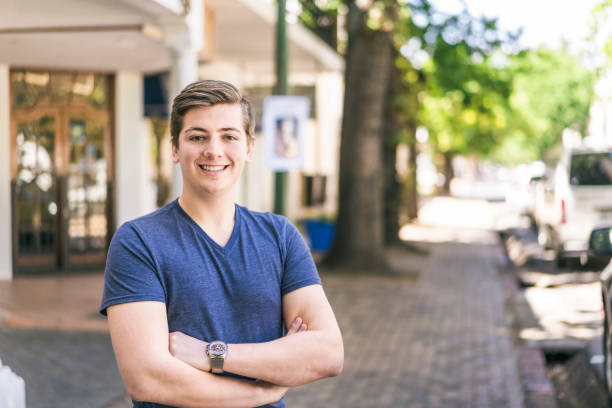 istock Confident young man standing outside shop 641975018