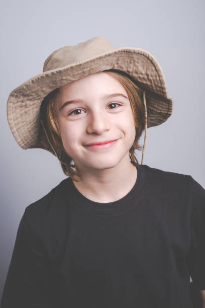istock young boy scout smiling portrait with hat on gray background 641975108