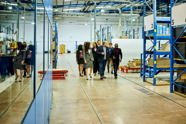 Business team visiting  in factory stock photo