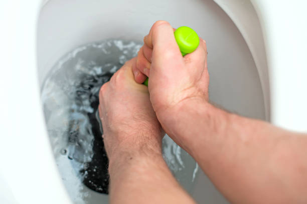 Cleaning stuck in a toilet. Black Woman cleans a clogged toilet. lifestyle at home, housework cleaning