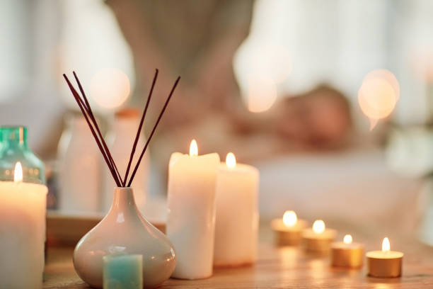 Cropped shot of various pampering essentials in a spa with a young woman in the background