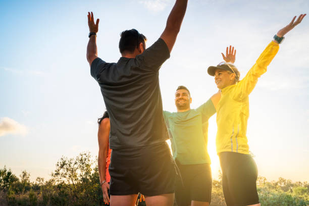 istock Sporty friends with hands raised during sunrise 641980852