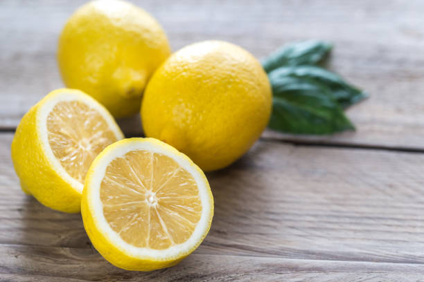 istock Fresh lemons on the wooden background 641985534