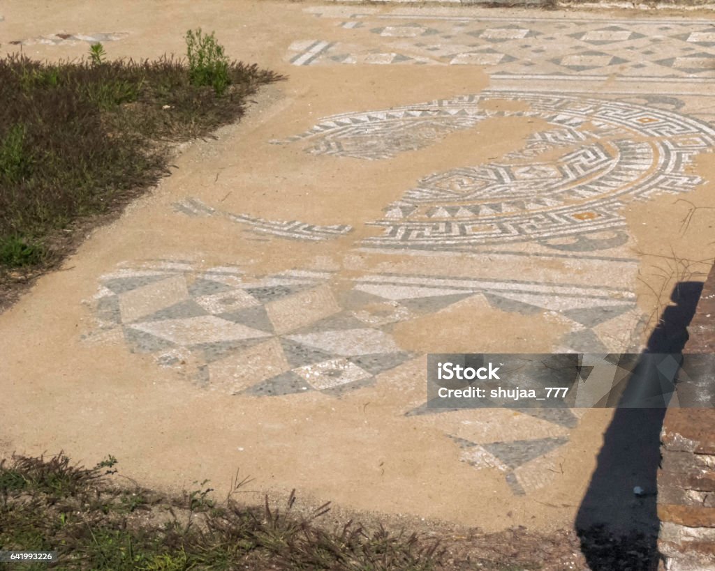 Ancient antique mosaic fragment Ancient antique mosaic fragment. Dion Archaeological Park, Pieria, Greece. Abandoned Stock Photo
