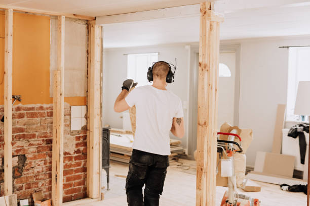 Man working and renovating a house. Mid age man doing some building.