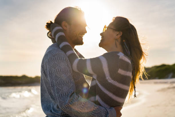 istock Loving young couple embracing at beach 641994274