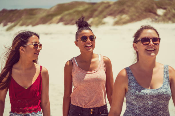 istock Happy female friends at beach during summer 641994992