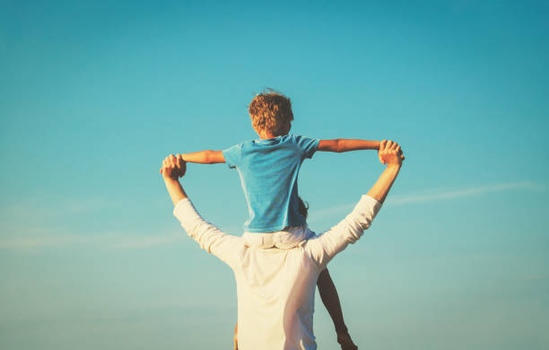 istock happy father and son playing on sky 641995252