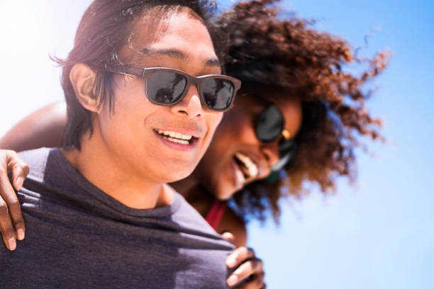 istock Young man piggybacking woman on sunny day 641995344